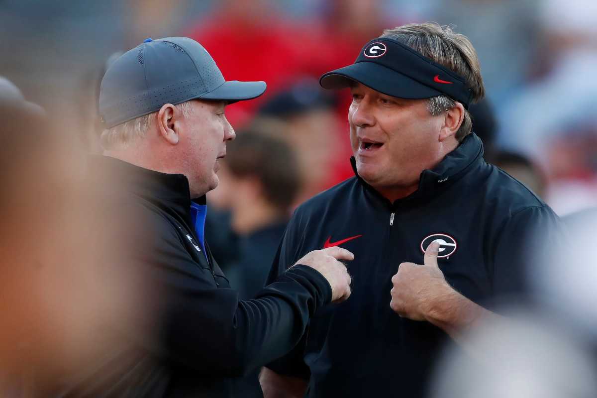 Kentucky Head Coach Mark Stoops talks with Georgia Head Coach Kirby Smart on the field prior to a game between the Bulldogs and Wildcats.Credit - Joshua Jones