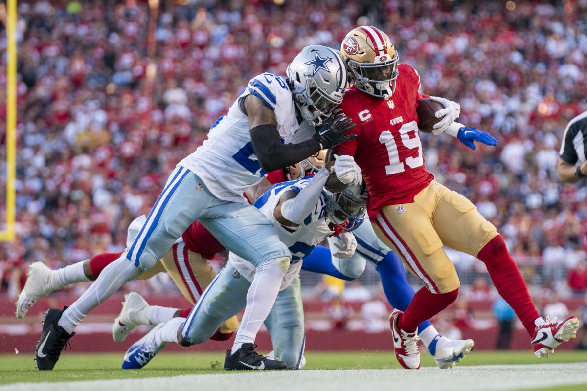 San Francisco 49ers wide receiver Deebo Samuel (19) is pushed out of bounds by Dallas Cowboys safety Malik Hooker (28) and cornerback DaRon Bland (26) during the first quarter at Levi's Stadium.