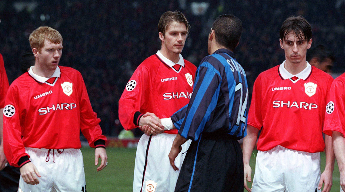 David Beckham shaking hands with Diego Simeone.