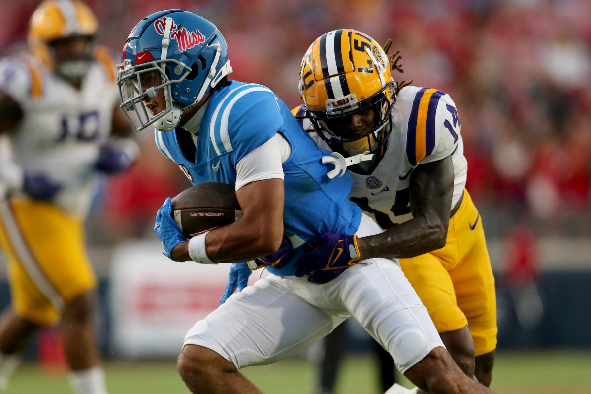 Sep 30, 2023; Oxford, Mississippi, USA; Mississippi Rebels wide receiver Jordan Watkins (11) runs after a catch as LSU Tigers defensive back Andre' Sam (14) makes the tackle during the first half at Vaught-Hemingway Stadium. Mandatory Credit: Petre Thomas-USA TODAY Sports