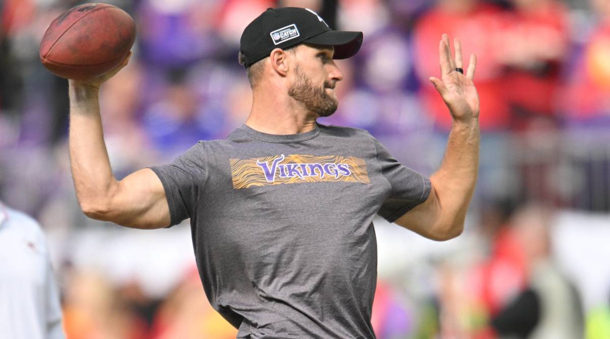 Vikings quarterback Kirk Cousins throws a ball during warmups before a game.