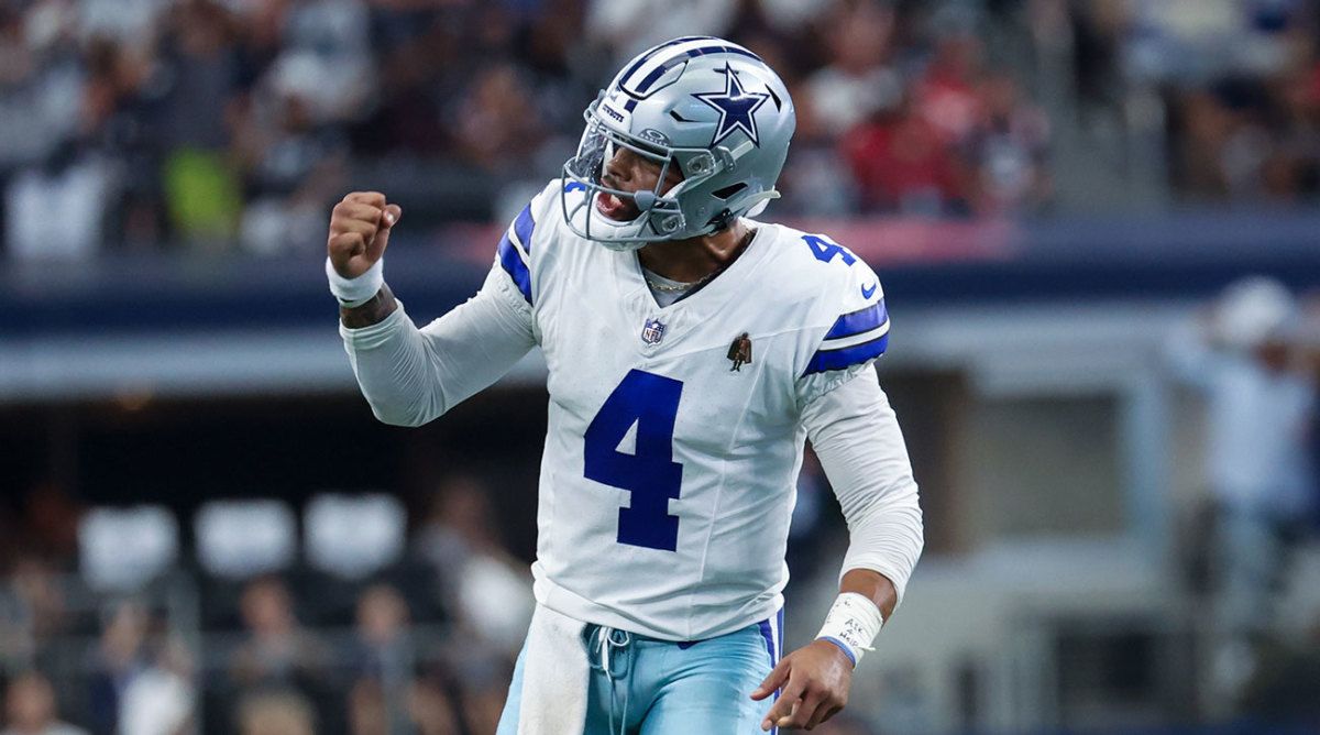 Dak Prescott pumps his fist after throwing a touchdown pass.