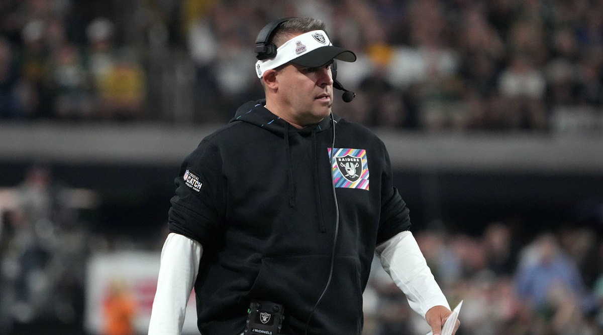 Josh McDaniels watches a Raiders game from the sideline