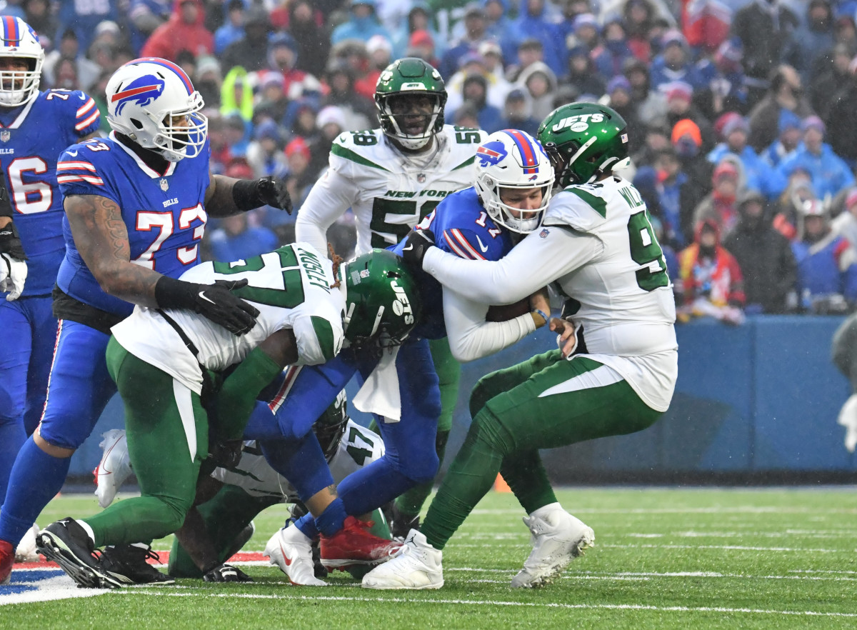 Buffalo Bills quarterback Josh Allen (17) is tackled by New York Jets defensive tackle Quinnen Williams (95) and linebacker C.J. Mosley (57) in the first quarter at Highmark Stadium.