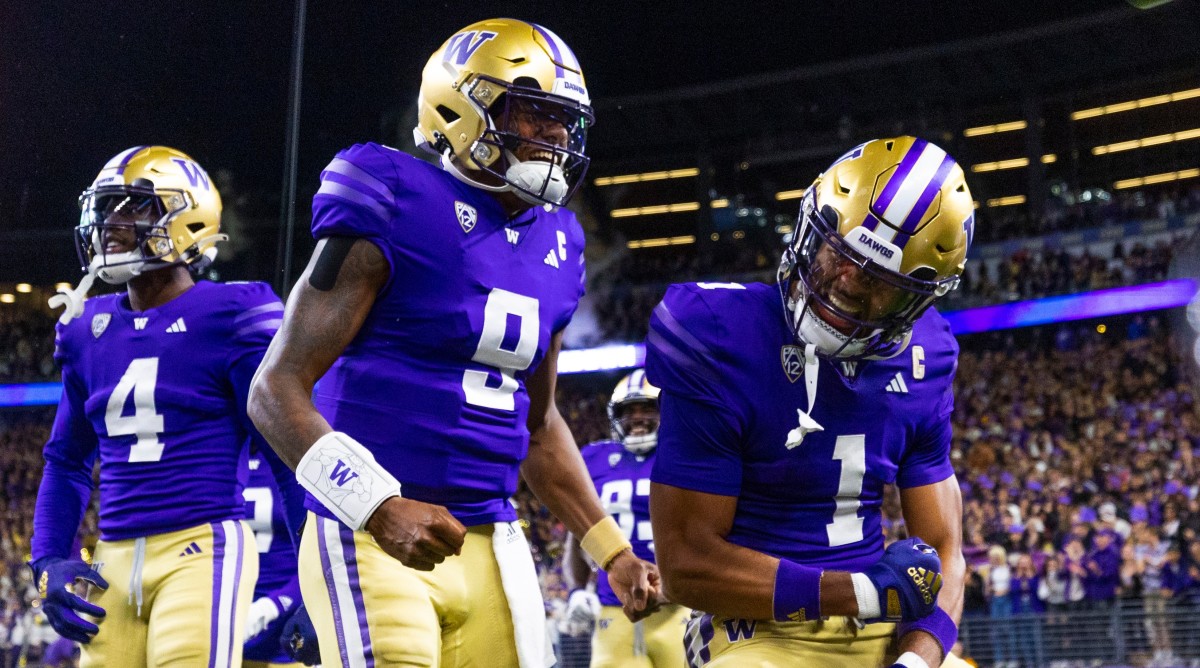 Washington quarterback Michael Penix Jr. celebrates with teammates after a touchdown.