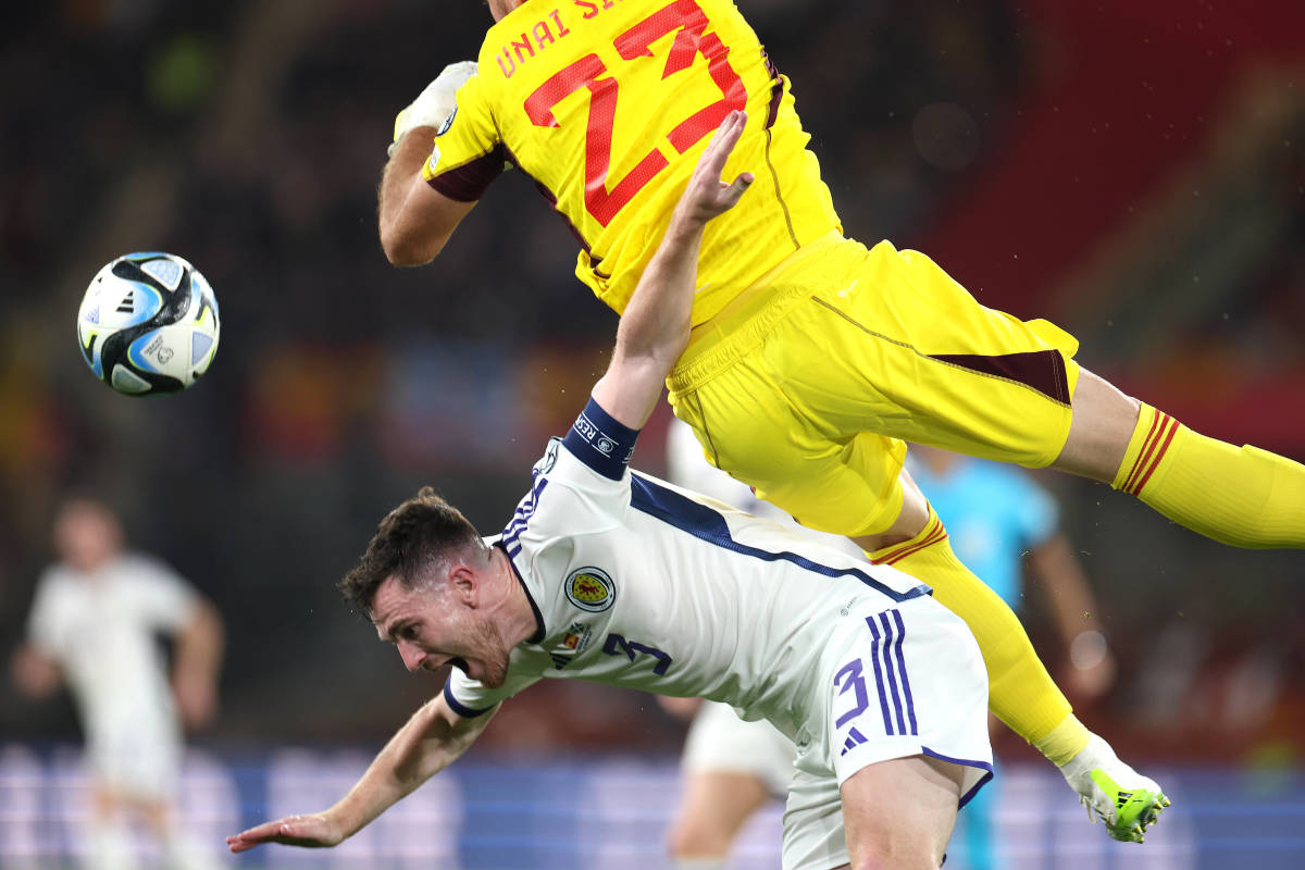 Scotland left-back Andy Robertson pictured falling to the ground after being struck by Spain goalkeeper Unai Simon during a game in October 2023