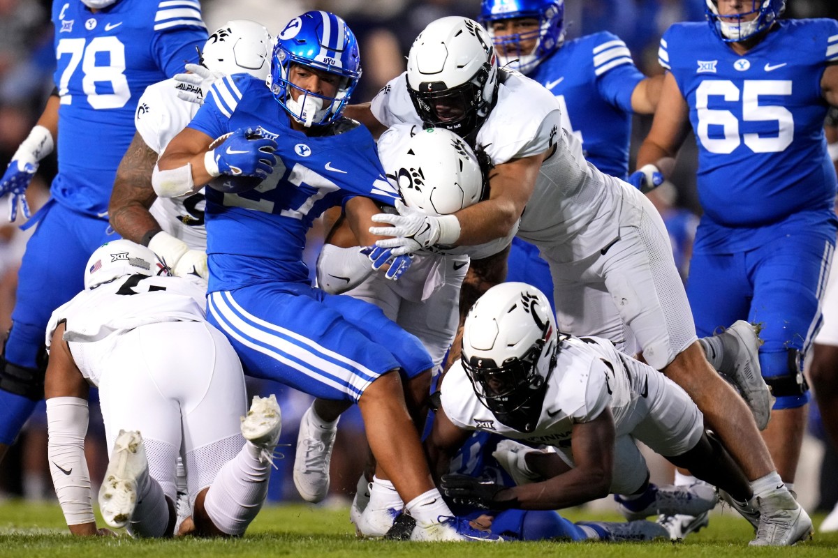 Brigham Young Cougars running back LJ Martin (27) is gang tackled by the Cincinnati Bearcats defense in the third quarter during a college football game between the Brigham Young Cougars and the Cincinnati Bearcats, Saturday, Sept. 30, 2023, at LaVell Edwards Stadium in Provo, Utah.