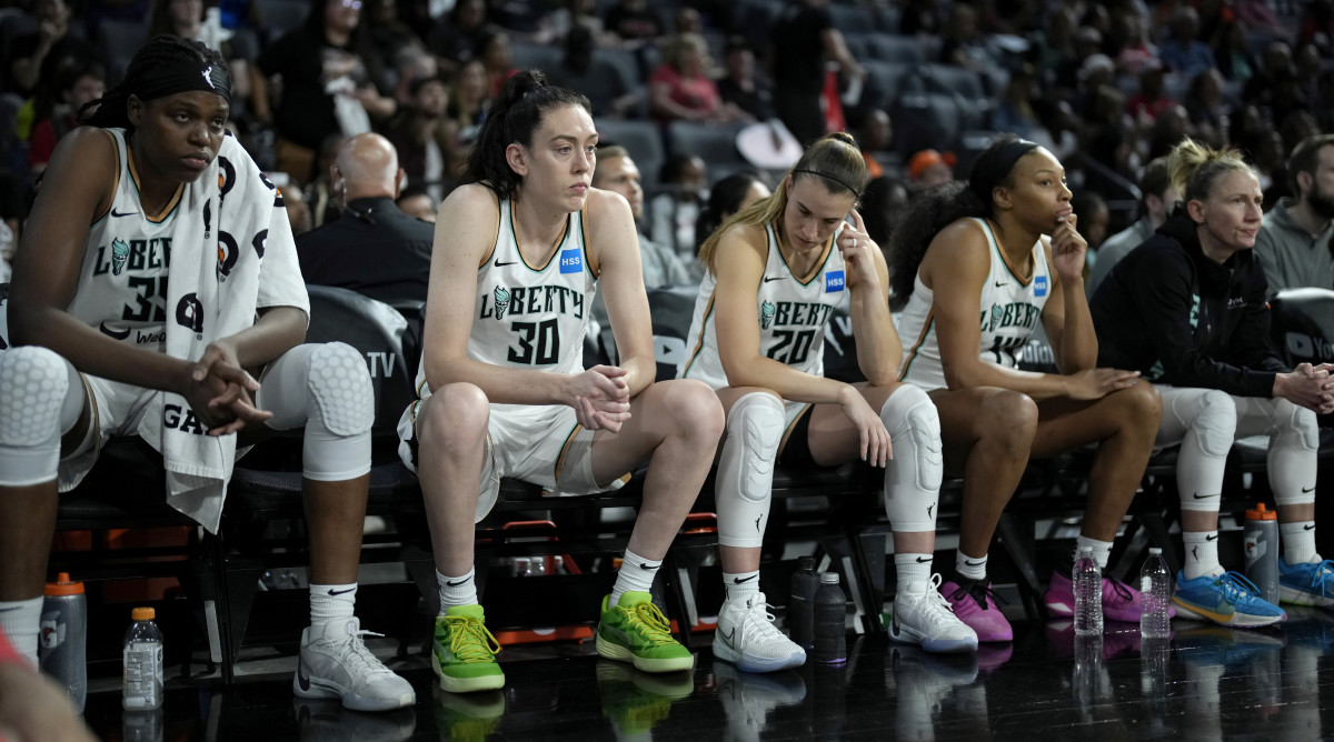 New York Liberty players Jonquel Jones, Breanna Stewart and Sabrina Ionescu sit on the bench as they trail the Las Vegas Aces in Game 2 of the WNBA Finals.