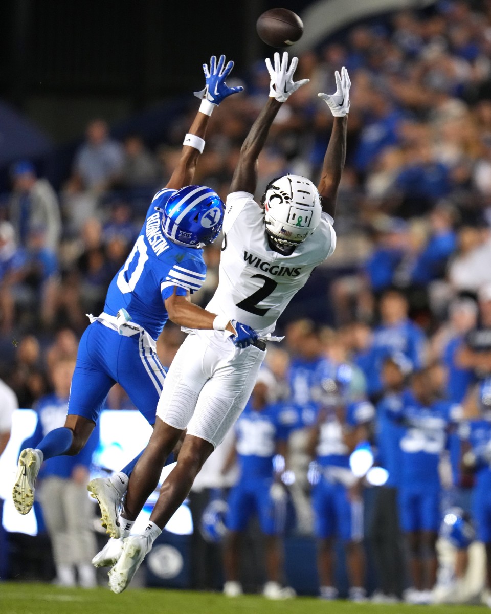 Brigham Young Cougars cornerback Jakob Robinson (0) defends a pass intended for Cincinnati Bearcats wide receiver Dee Wiggins (2) in the first quarter during a college football game between the Brigham Young Cougars and the Cincinnati Bearcats