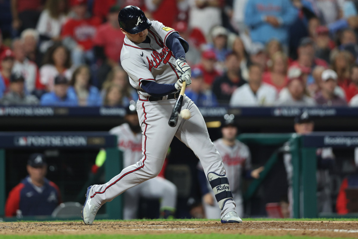 Oct 12, 2023; Philadelphia, Pennsylvania, USA; Atlanta Braves third baseman Austin Riley (27) hits a single against the Philadelphia Phillies during the sixth inning during game four of the NLDS for the 2023 MLB playoffs at Citizens Bank Park.