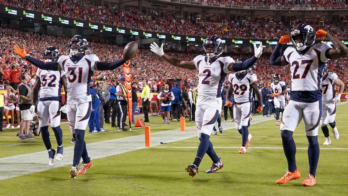 Denver Broncos safety Justin Simmons, cornerback Pat Surtain II, and cornerback Damarri Mathis celebrate