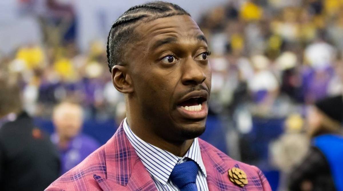 ESPN analyst Robert Griffin III speaks at halftime while broadcasting a bowl game.