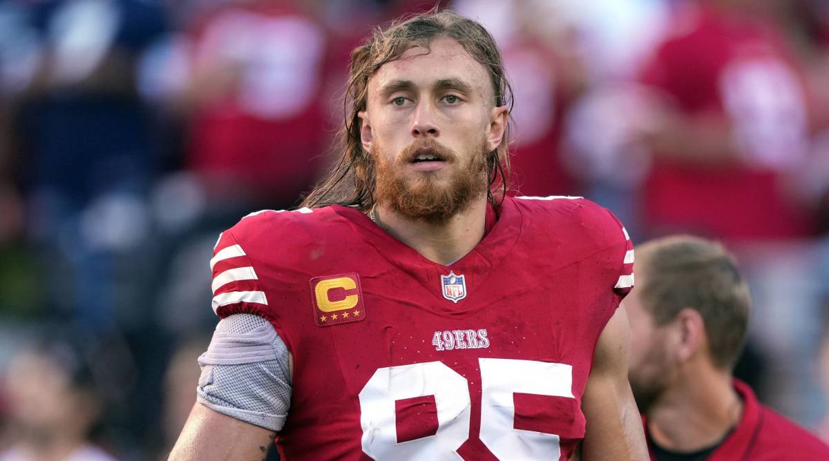 49ers tight end George Kittle looks on without a helmet before a game.
