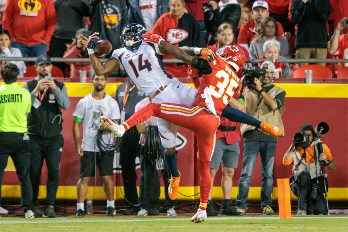 Oct 12, 2023; Kansas City, Missouri, USA; Denver Broncos wide receiver Courtland Sutton (14) goes up for a reception in the end zone around Kansas City Chiefs cornerback Jaylen Watson (35) during the fourth quarter at GEHA Field at Arrowhead Stadium. Mandatory Credit: William Purnell-USA TODAY Sports  