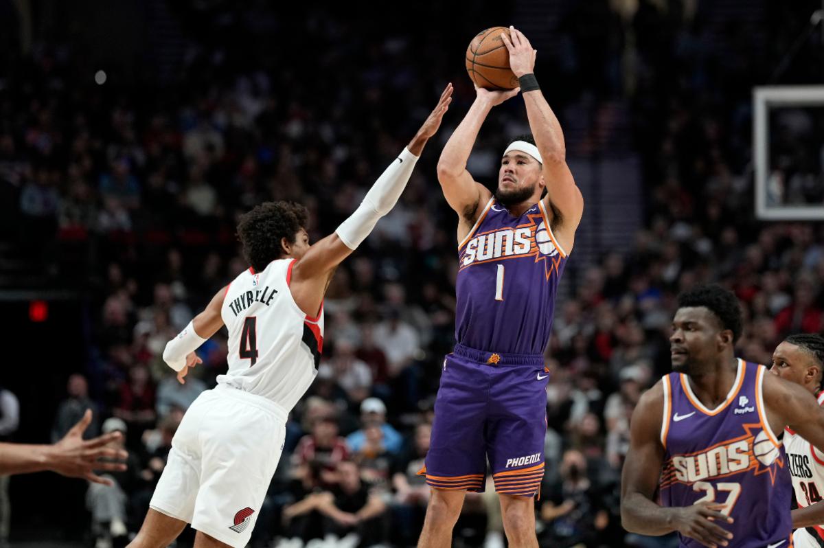 Phoenix Suns shooting guard Devin Booker (1) shoots the ball over Portland Trail Blazers shooting guard Matisse Thybulle (4) during the first half at Moda Center.