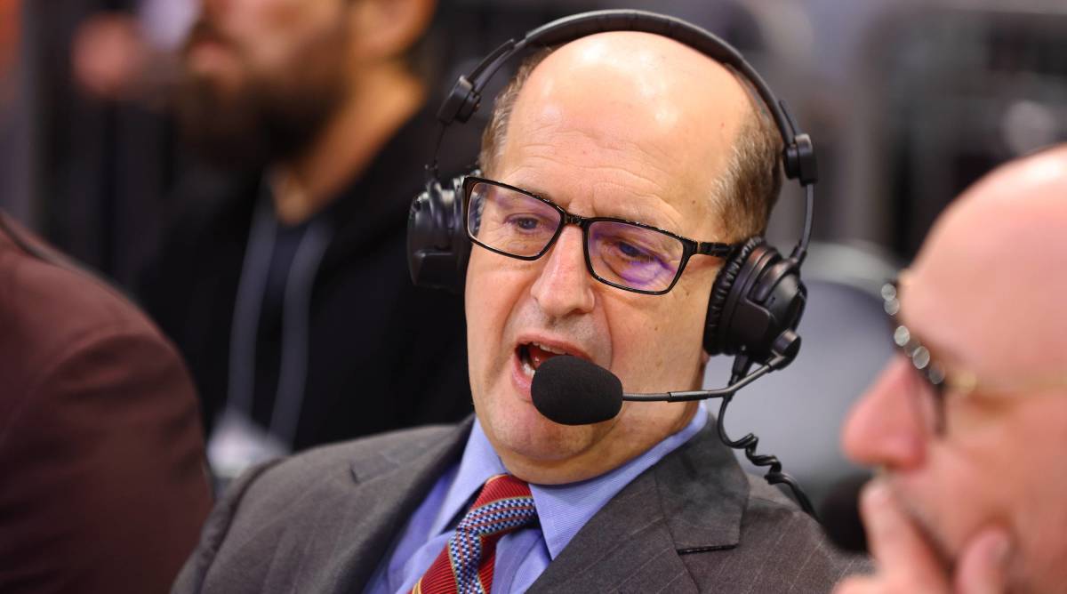 ESPN broadcaster Jeff Van Gandy speaks into a headset while broadcasting in a game.