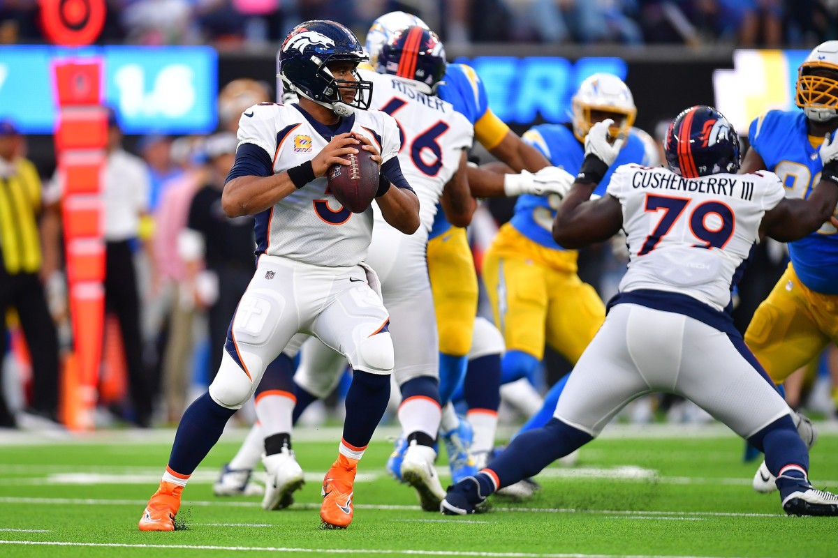 Oct 17, 2022; Inglewood, California, USA; Denver Broncos quarterback Russell Wilson (3) drops back to pass as center Lloyd Cushenberry III (79) provides coverage against the Los Angeles Chargers during the first half at SoFi Stadium. Mandatory Credit: Gary A. Vasquez-USA TODAY Sports  