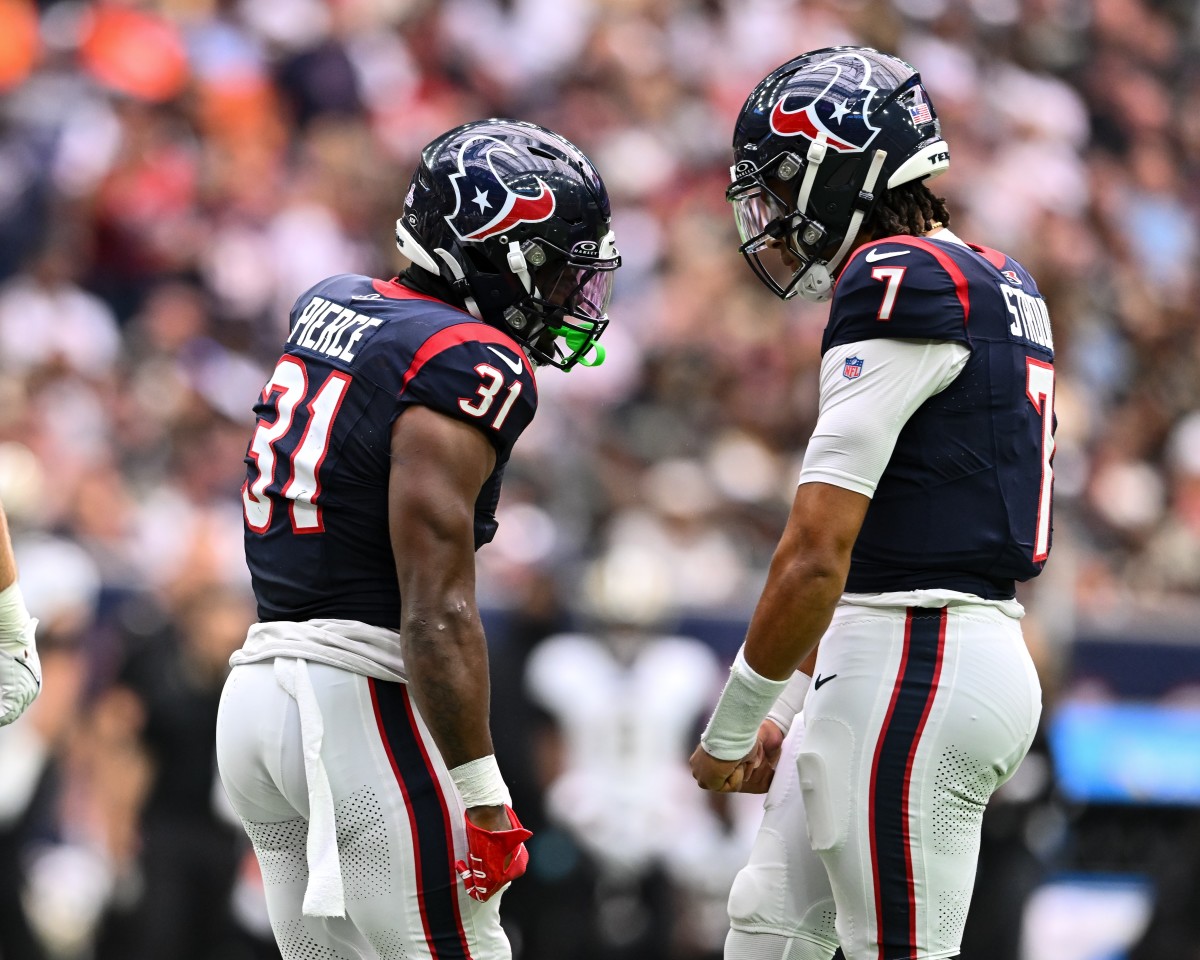 Houston Texans running back Dameon Pierce (31) and quarterback C.J. Stroud (7) reacts during the second quarter against the New Orleans Saints at NRG Stadium.
