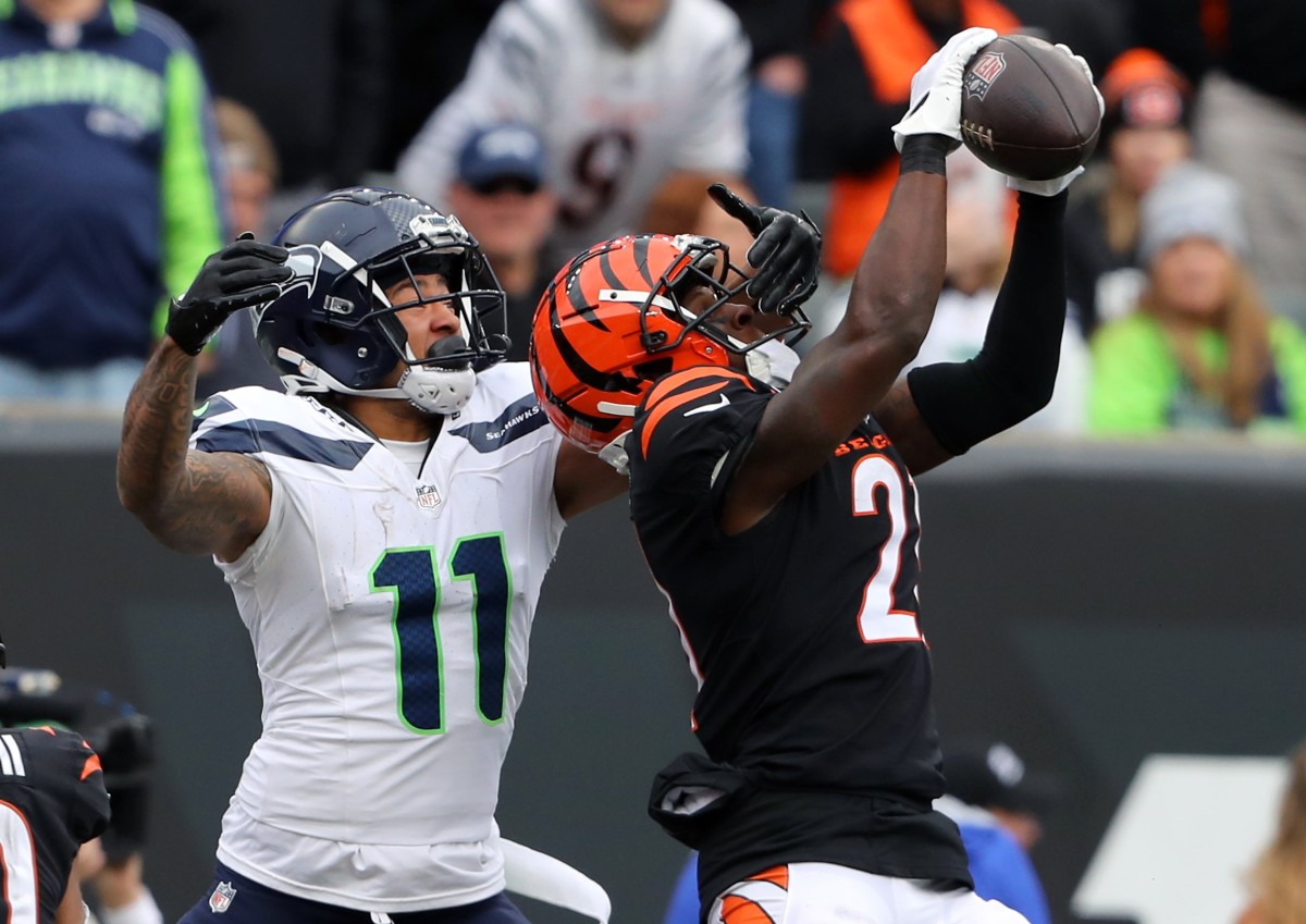 Cincinnati Bengals cornerback Mike Hilton (21) intercepts the pass in front of Seattle Seahawks wide receiver Jaxon Smith-Njigba (11) during the third quarter at Paycor Stadium.