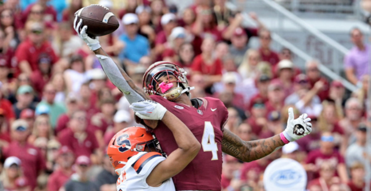 Florida State Seminoles wide receiver Keon Coleman catches a one-handed pass during a college football game in the ACC.