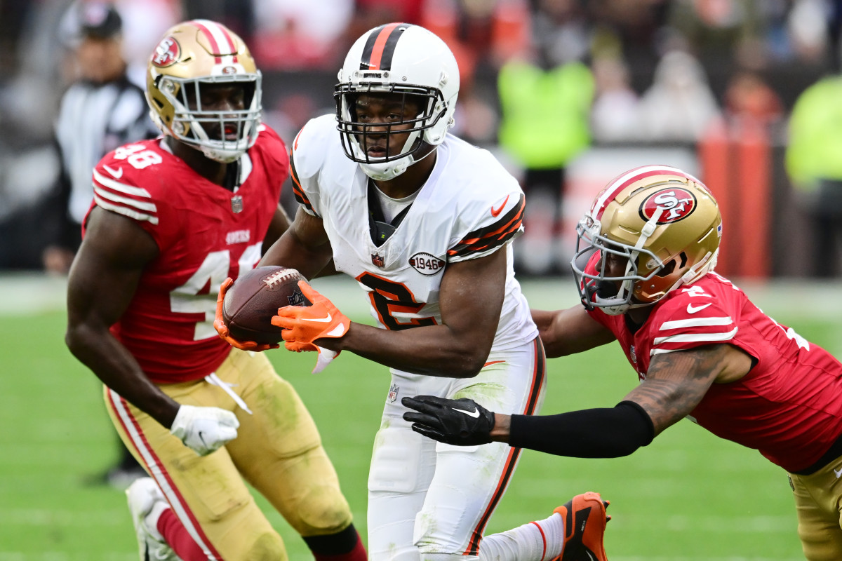 Oct 15, 2023; Cleveland, Ohio, USA; Cleveland Browns wide receiver Amari Cooper (2) runs with the ball after a catch as San Francisco 49ers cornerback Deommodore Lenoir (2) and linebacker Oren Burks (48) defend during the second half at Cleveland Browns Stadium. 