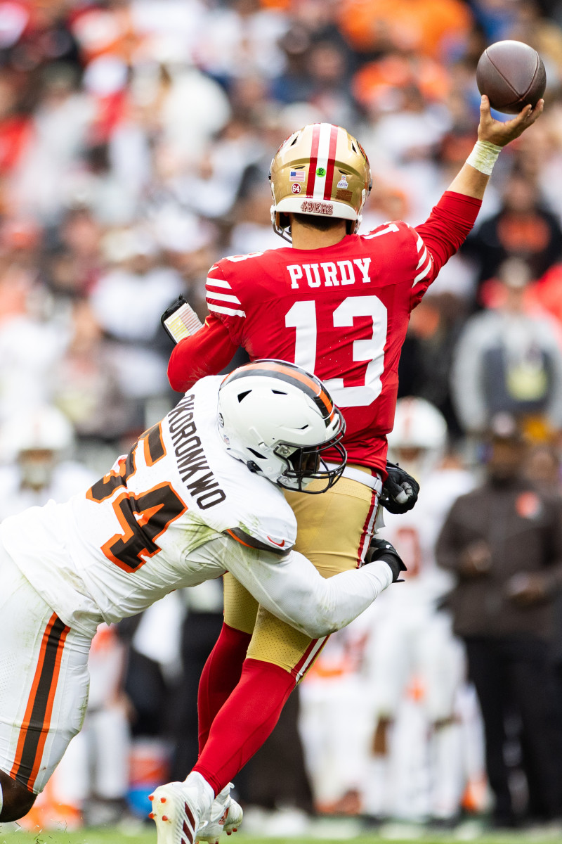 Oct 15, 2023; Cleveland, Ohio, USA; Cleveland Browns defensive end Ogbo Okoronkwo (54) tackles San Francisco 49ers quarterback Brock Purdy (13) as he throws the ball away during the fourth quarter at Cleveland Browns Stadium.