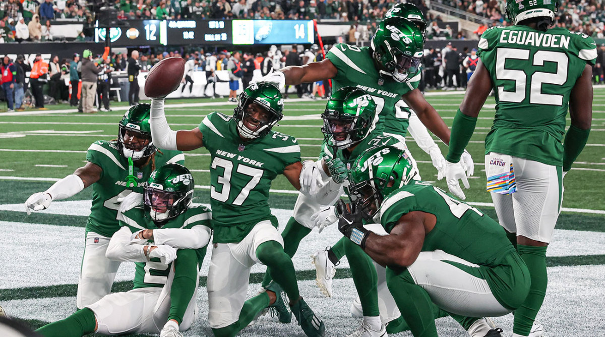 The Jets celebrate in the end zone as a team during a win over the Eagles