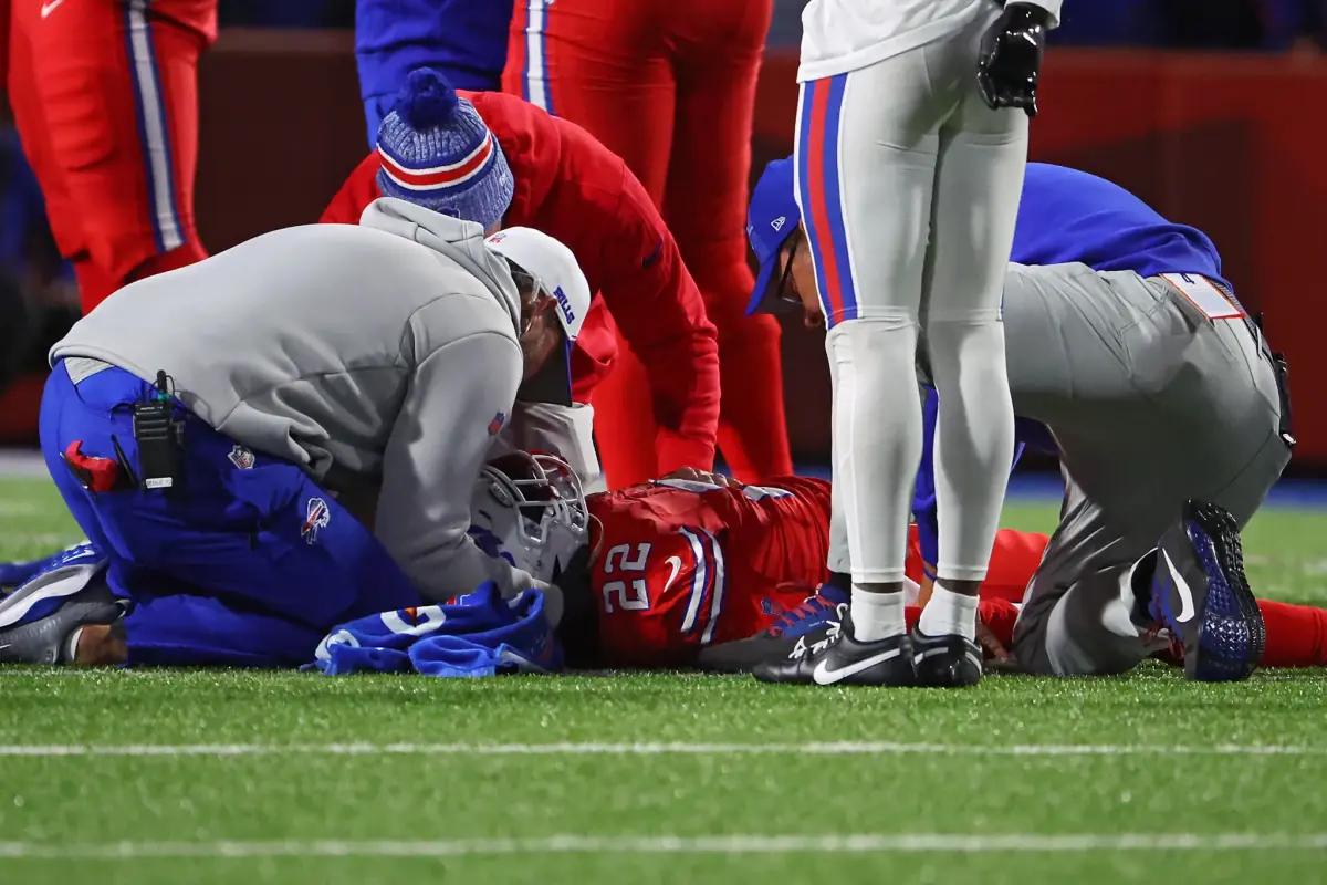 Trainers attend to Harris after his injury on Sunday night.
