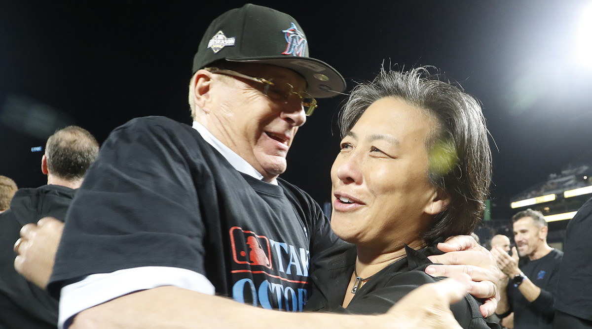 Marlins owner Bruce Sherman (left) and general manager Kim Ng (right) embrace on the field after the Marlins defeated the Pirates at PNC Park to secure a berth in the 2023 MLB playoffs.