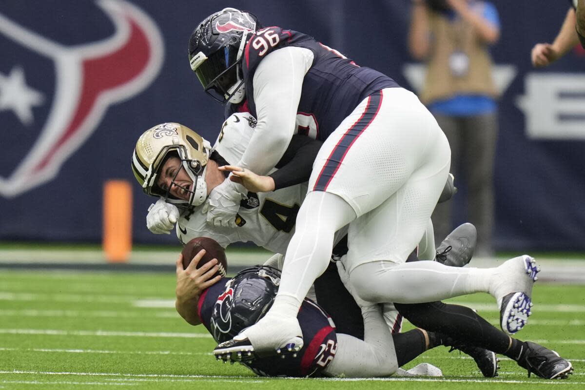 Saints QB Derek Carr gets sacked by the Texans' defense on Oct. 15, 2023.