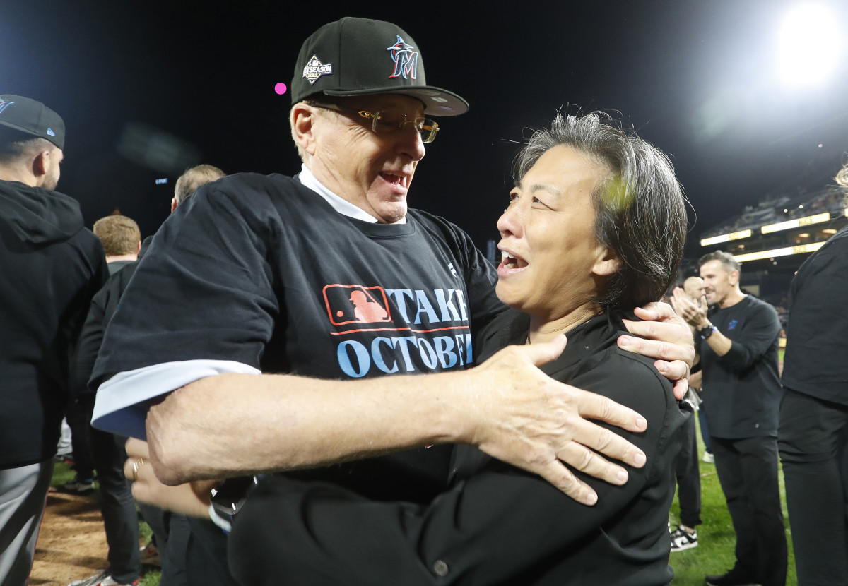 owner Bruce Sherman (left) and general manager Kim Ng (right) embrace on the field after the Marlins defeated the Pittsburgh Pirates