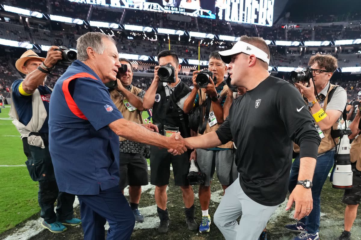 McDaniels shakes hands with Patriots coach Bill Belichick after a game.
