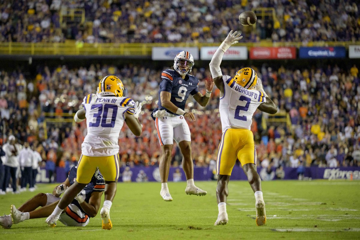 Oct 14, 2023; Baton Rouge, Louisiana, USA; Auburn Tigers quarterback Robby Ashford (9) throws a two-point conversion against LSU Tigers defensive end Ovie Oghoufo (2) during the fourth quarter at Tiger Stadium. Mandatory Credit: Matthew Hinton-USA TODAY Sports 