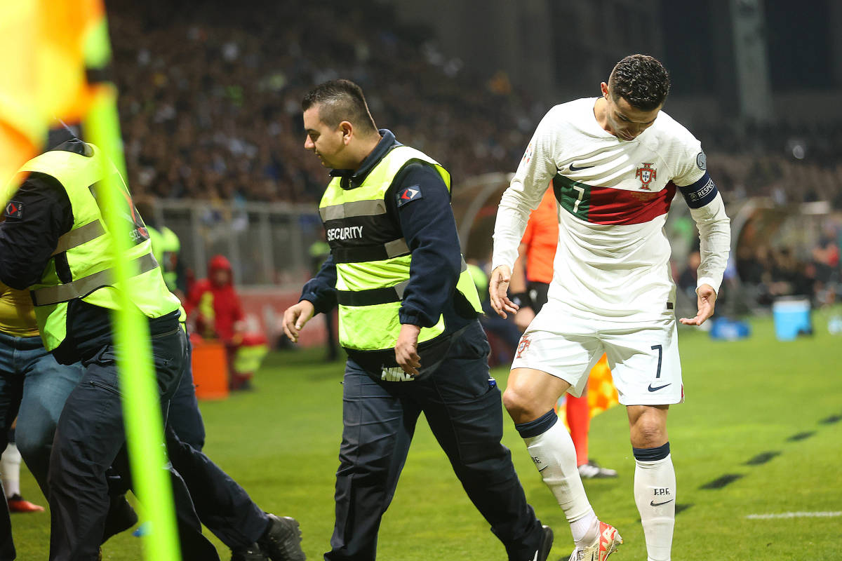 Cristiano Ronaldo pictured looking down at his right foot after appearing to have been stood on by a pitch invader during Portugal's 5-0 win over Bosnia and Herzegovina in October 2023