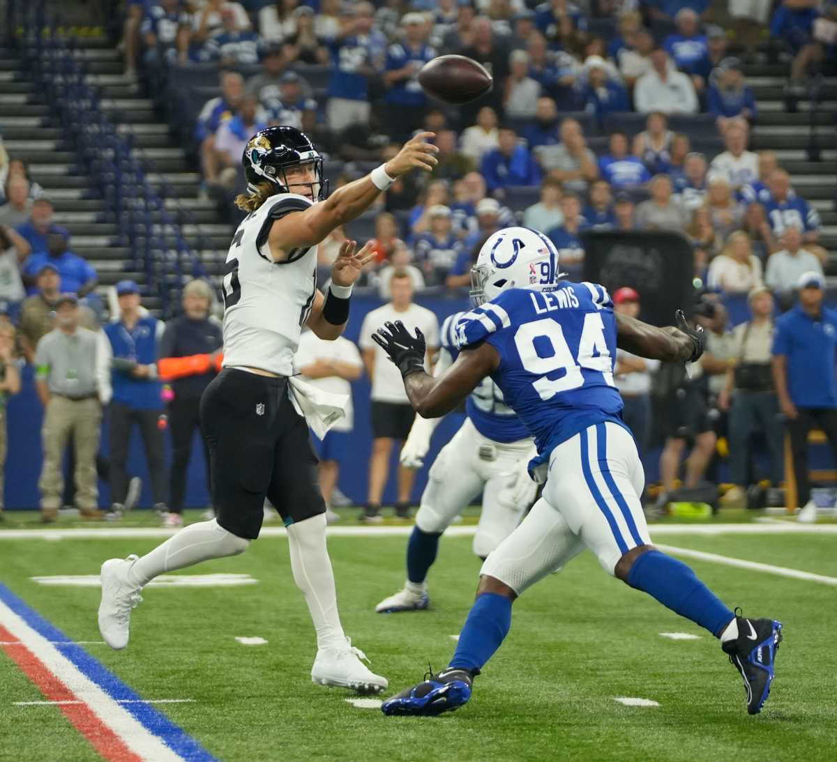 Jacksonville Jaguars quarterback Trevor Lawrence (16) throws the ball over Indianapolis Colts defensive end Tyquan Lewis (94), during a game against the Jacksonville Jaguars at Lucas Oil Stadium in Indianapolis.
