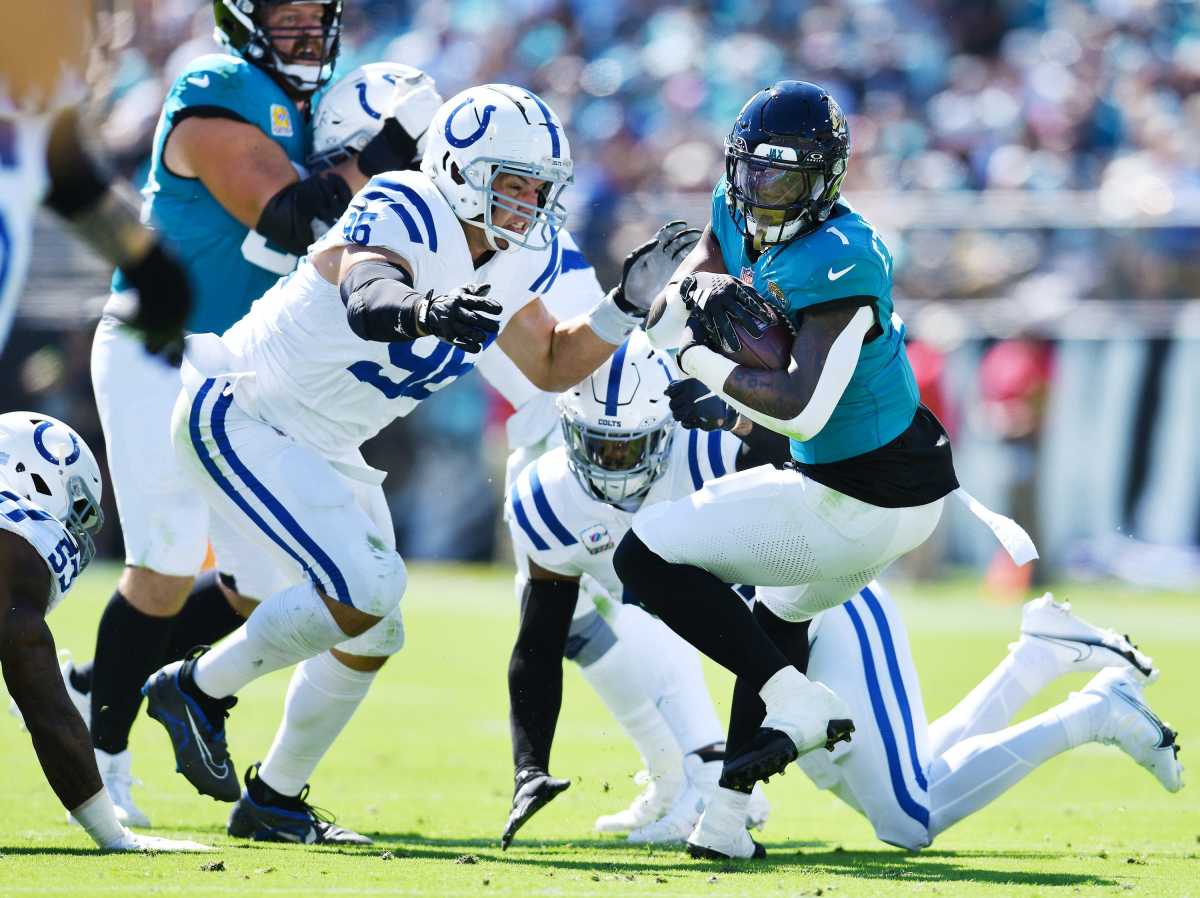 Indianapolis Colts defensive tackle Taven Bryan (96) and teammates try to stop Jacksonville Jaguars running back Travis Etienne Jr. (1) during first quarter action. The Jacksonville Jaguars hosted the Indianapolis Colts at EverBank Stadium in Jacksonville, FL Sunday, October 15, 2023. The Jaguars ended the first half with a 21 to 6 lead. [Bob Self/Florida Times-Union]