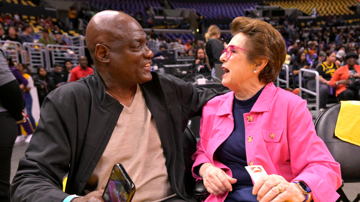 May 19, 2023; Los Angeles, California, USA; Former Los Angeles Lakers Michael Cooper talks with former tennis player and activist Billie Jean King as they attend the game between the Los Angeles Sparks and the Phoenix Mercury at Crypto.com Arena.