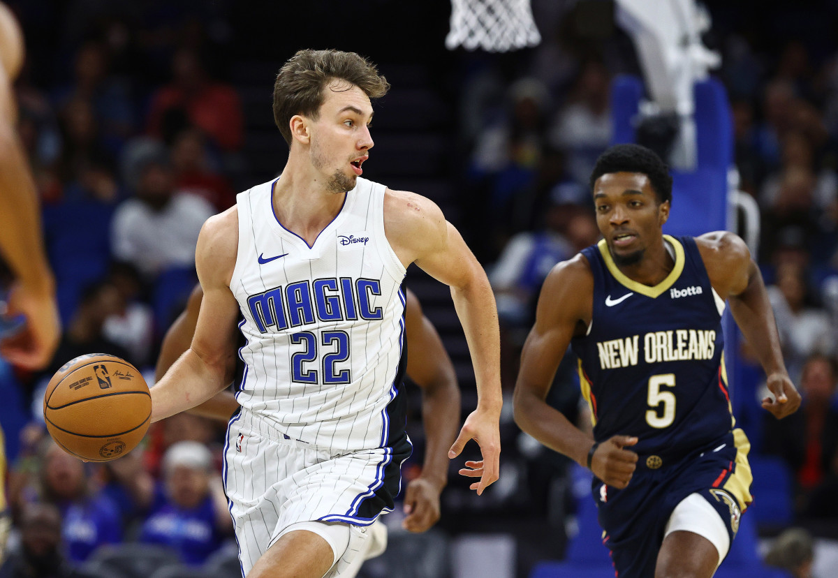 Orlando Magic forward Franz Wagner (22) dribbles as New Orleans Pelicans forward Herbert Jones (5) defends during the first quarter at Amway Center.