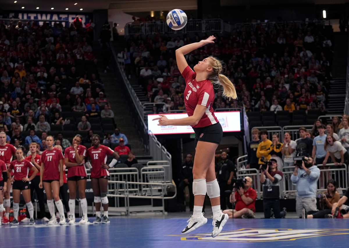 Wisconsin libero Saige Damrow serves during a volleyball match against Marquette on Sept. 20, 2023, at Fiserv Forum. Official attendance was 17,037, making it the largest indoor regular-season crowd for a volleyball match in NCAA history.
