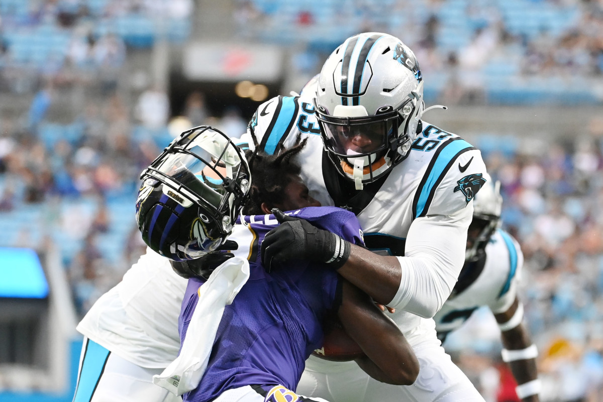 Aug 21, 2021; Charlotte, North Carolina, USA; Carolina Panthers defensive end Brian Burns (53) knocks off the helmet of Baltimore Ravens quarterback Tyler Huntley (2) during a tackle in the first quarter at Bank of America Stadium. 