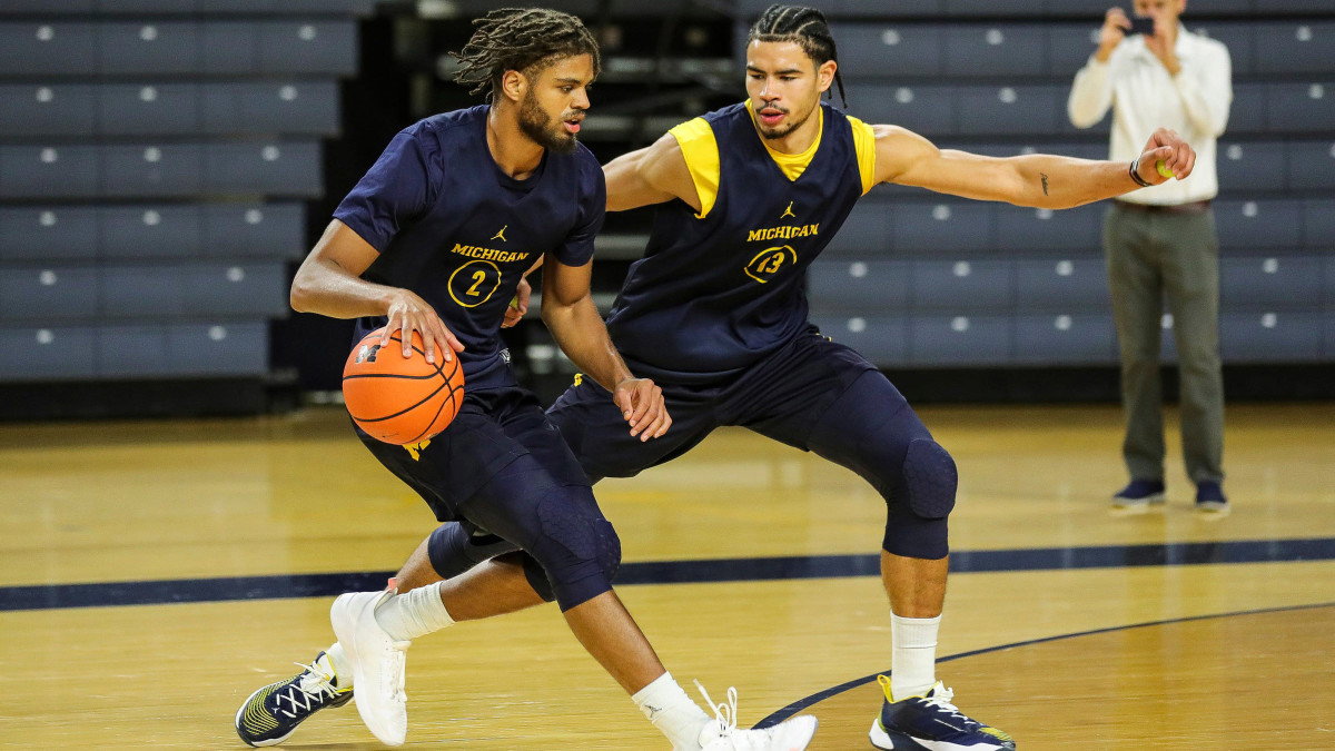 Michigan forward Tray Jackson practices with forward Olivier Nkamhoua.