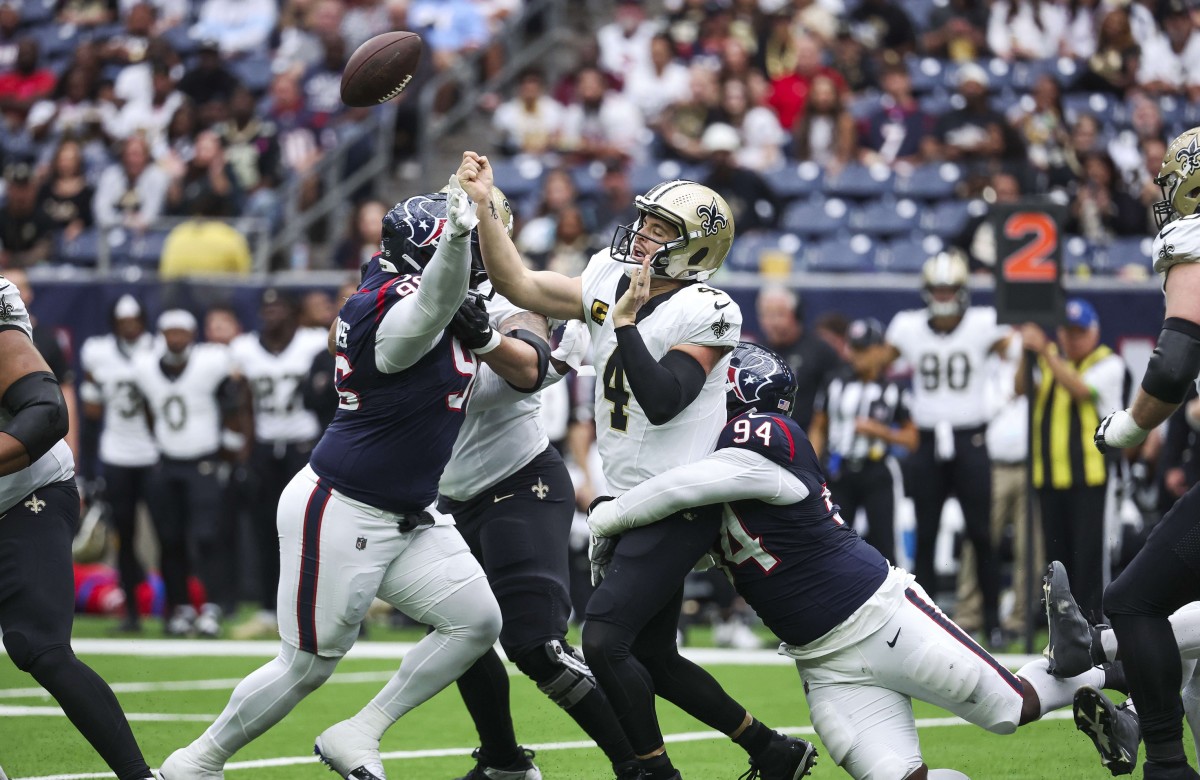 Oct 15, 2023; New Orleans Saints quarterback Derek Carr (4) attempts a pass as Houston Texans defensive tackle Khalil Davis (94) applies defensive pressure. Mandatory Credit: Troy Taormina-USA TODAY Sports