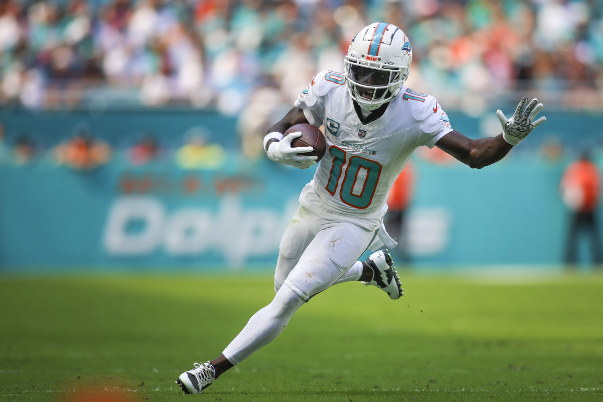 Oct 15, 2023; Miami Gardens, Florida, USA; Miami Dolphins wide receiver Tyreek Hill (10) runs with the football against the Carolina Panthers during the second quarter at Hard Rock Stadium. Mandatory Credit: Sam Navarro-USA TODAY Sports