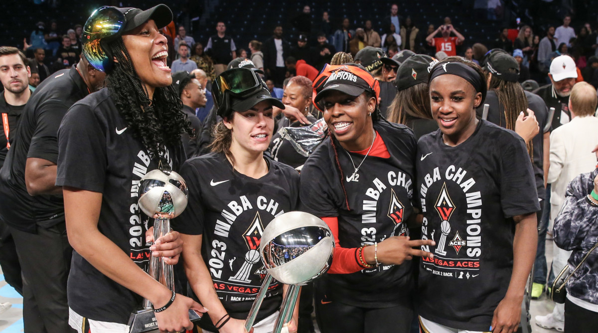 A’ja Wilson, Kelsey Plum, Chelsea Gray and Jackie Young hold the WNBA championship trophy after defeating the Liberty in the Finals.