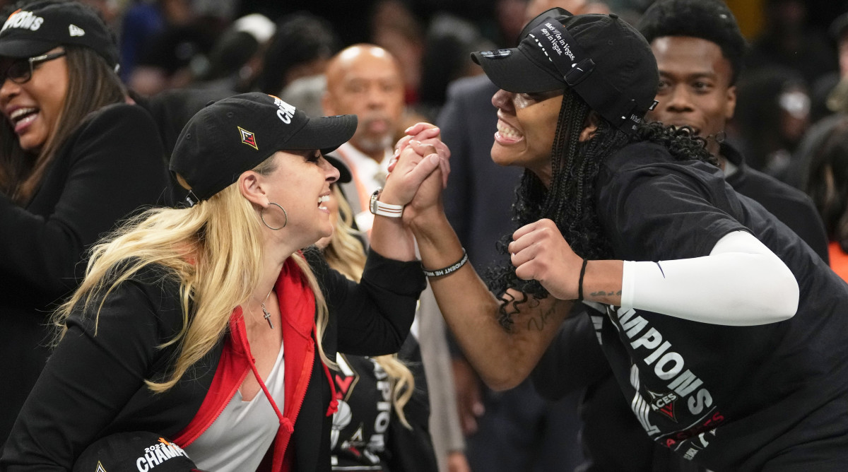 Las Vegas Aces head coach Becky Hammon holds A’ja Wilson’s hand while celebrating their WNBA Finals win over the Liberty.