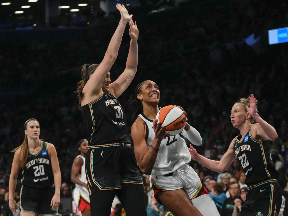 Las Vegas Aces’ A’ja Wilson drives to the basket as New York Liberty’s Stefanie Dolson and Courtney Vandersloot defends in Game 4 of the WNBA Finals.