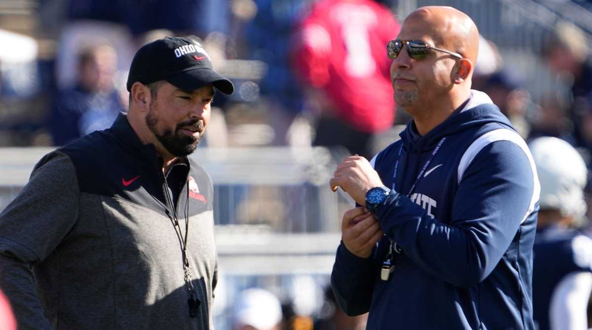 Ohio State coach Ryan Day, left, talks to Penn State coach James Franklin before their 2022 game