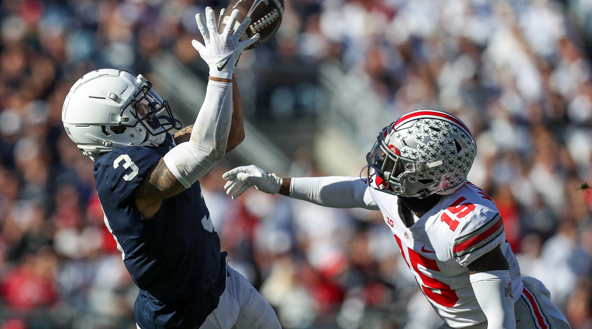 Penn State wide receiver Parker Washington, left, makes a catch as Ohio State safety Tanner McCalister defends during 2022 game