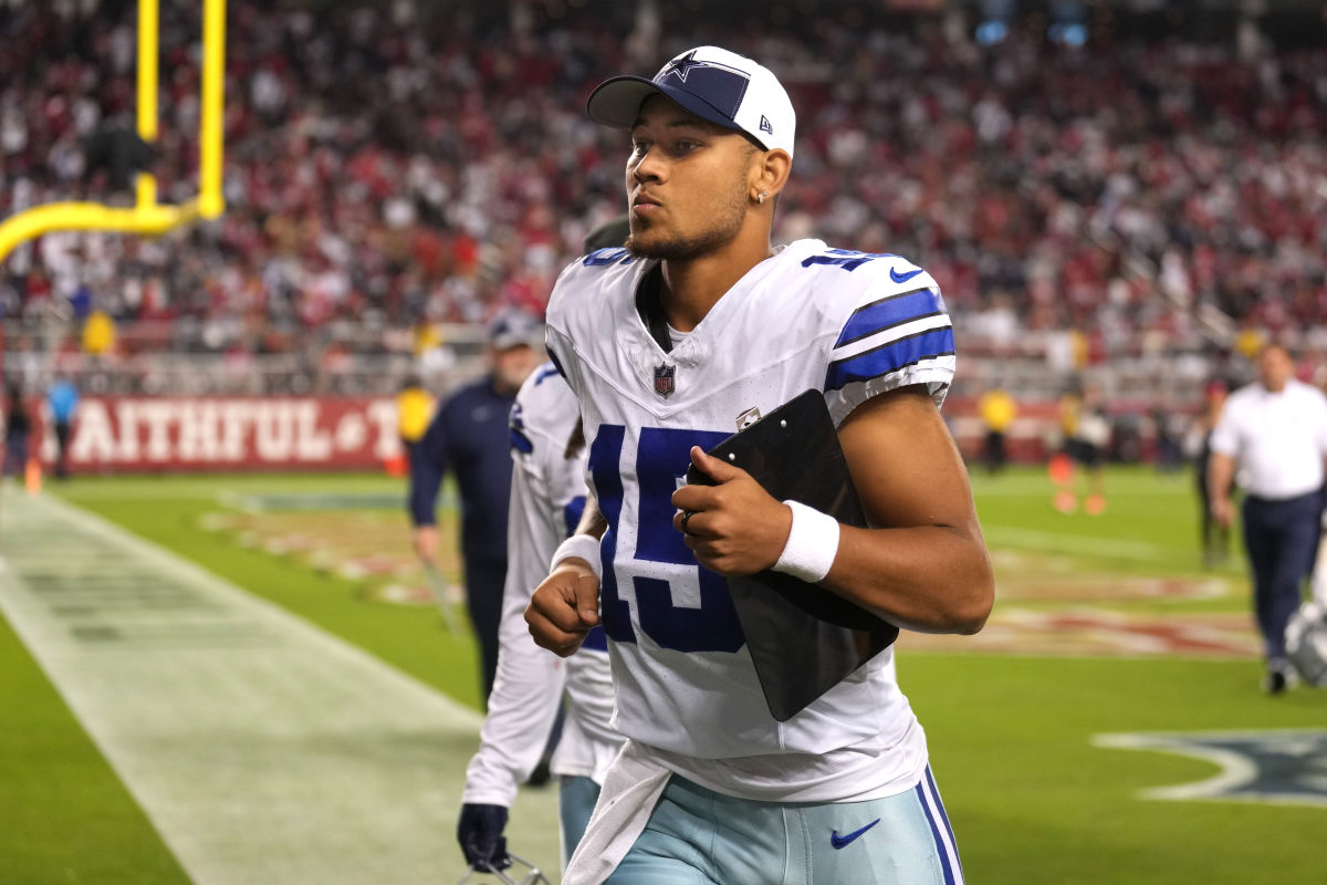 Quarterback Trey Lance jogs off the field during halftime against the San Francisco 49ers