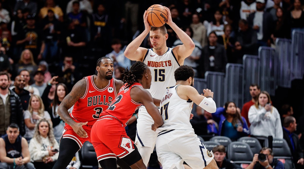 Nuggets center Nikola Jokic (15) controls the ball against Bulls center Andre Drummond (3) as guards Jamal Murray (27) and Ayo Dosunmu (12) battle for position.
